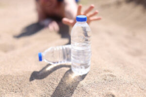 Person increasing water intake while taking GLP-1 medications with wellness support from Flow Wellness