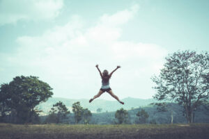 Jumping posture happy holidays Nature trails, forests, mountains