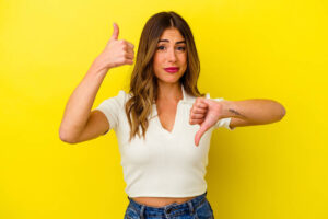 showing thumbs up and thumbs down, difficult choose concept