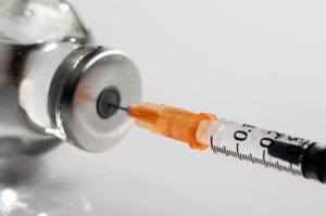 macro photography of a syringe ready to put a vaccine
