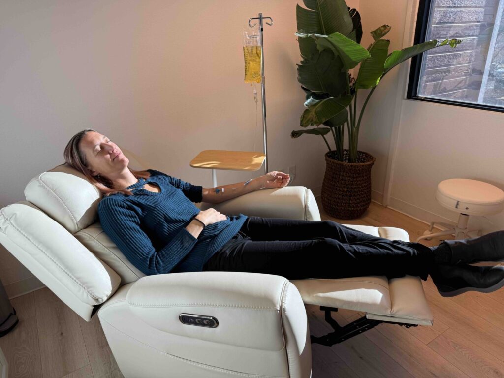Patient relaxing with IV drip therapy at Flow Wellness Bend