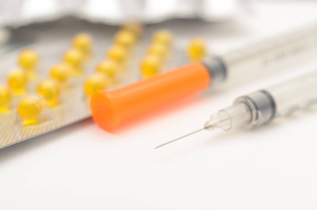 pills and syringe. Flow Wellness.
