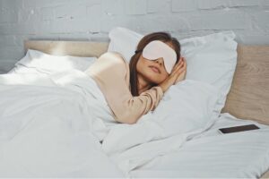 Woman resting peacefully after finding relief from migraine symptoms with IV therapy at Flow Wellness