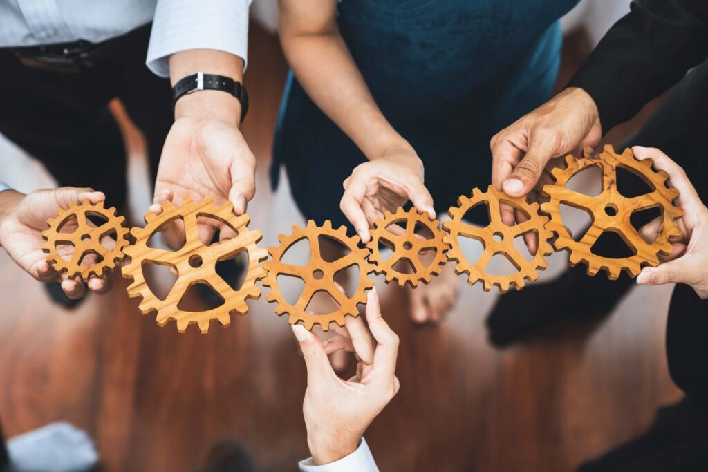People connecting gears together